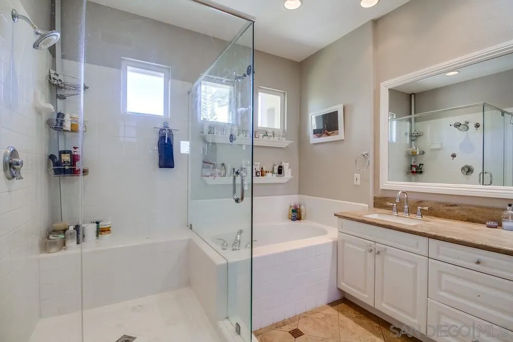 2305 Falkirk Row La Jolla, CA 92037 - Photo 34 of 36 a bathroom with a tub sink and mirror
