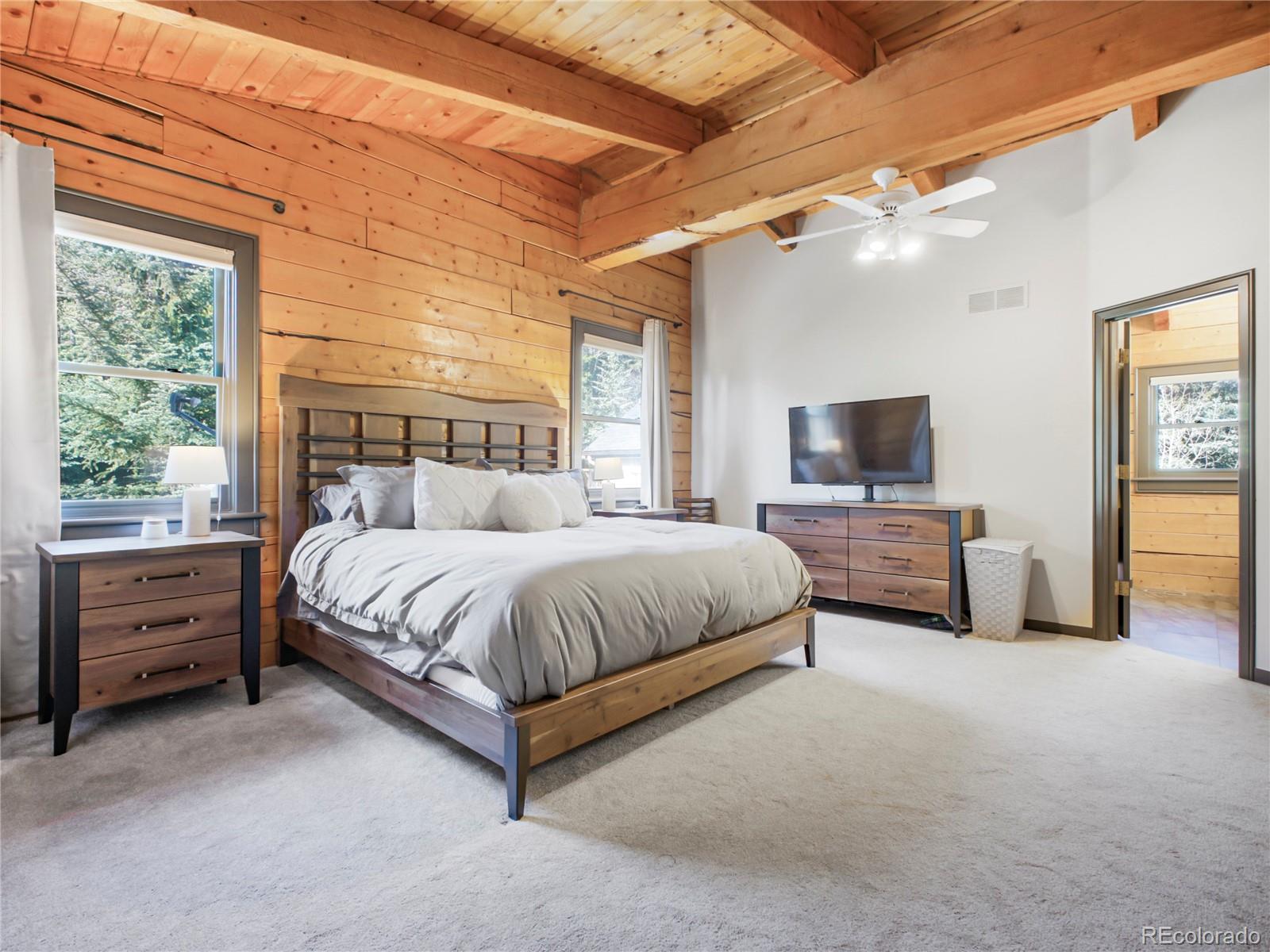 24 Pine Valley Road Evergreen, CO 80439 - Photo 16 of 50 a spacious bedroom with a bed and window