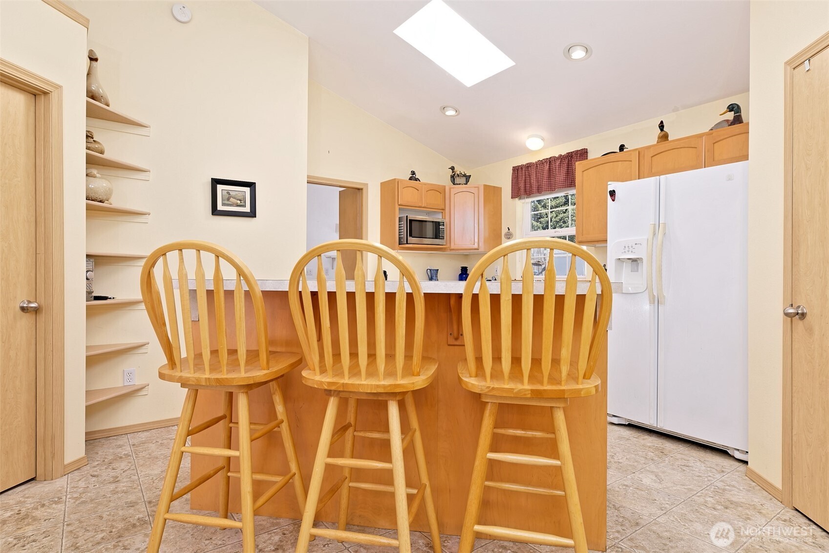 1091 E Trail Belfair, WA 98528 - Photo 16 of 31 a view of a kitchen with furniture and a refrigerator