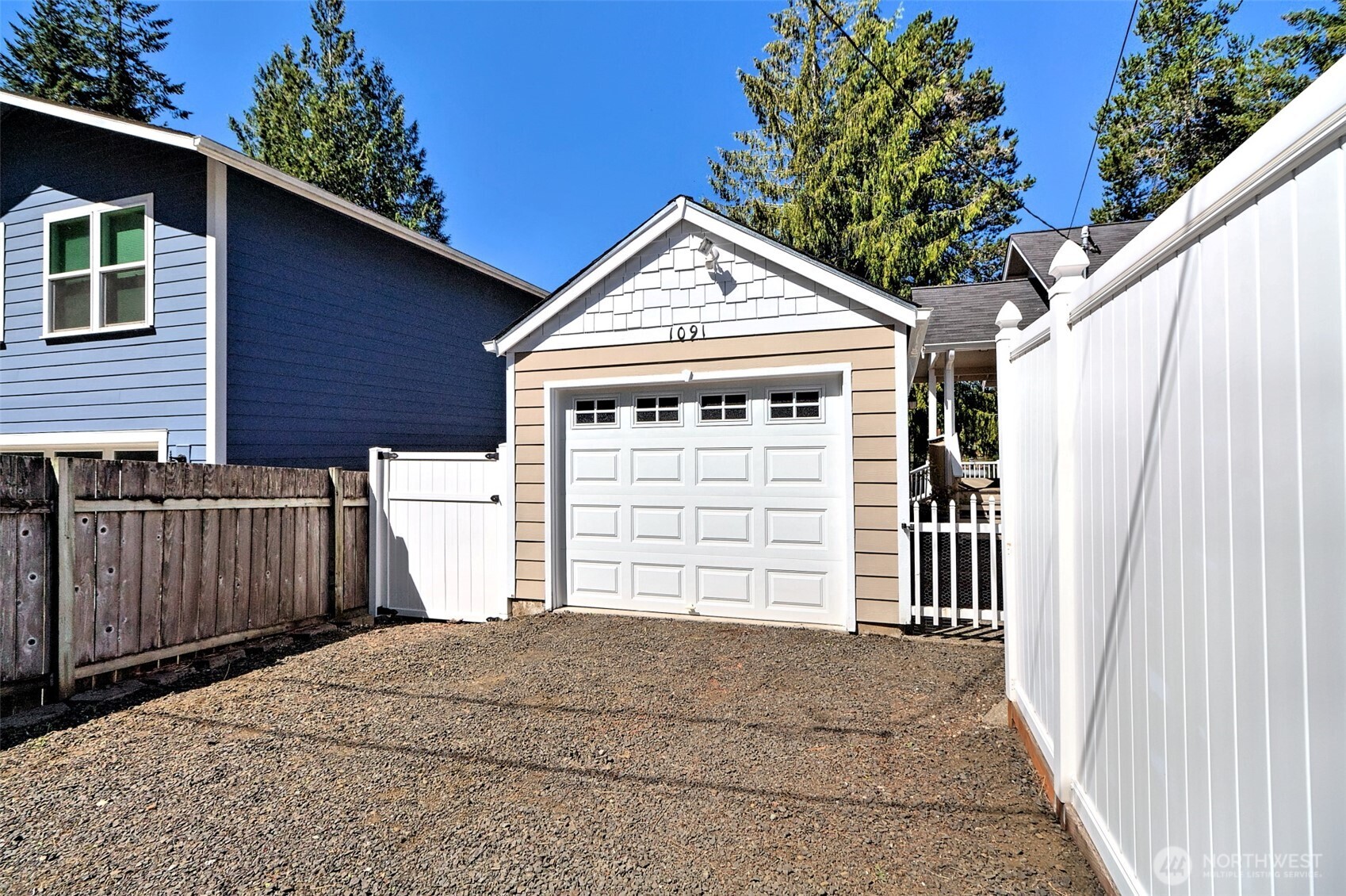 1091 E Trail Belfair, WA 98528 - Photo 6 of 31 a front view of a house with a garage