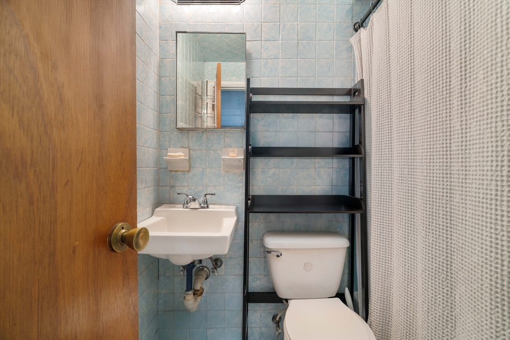 99 Prince Street, Unit 6 Boston, MA 02113 - Photo 8 of 14 a bathroom with a sink toilet and mirror