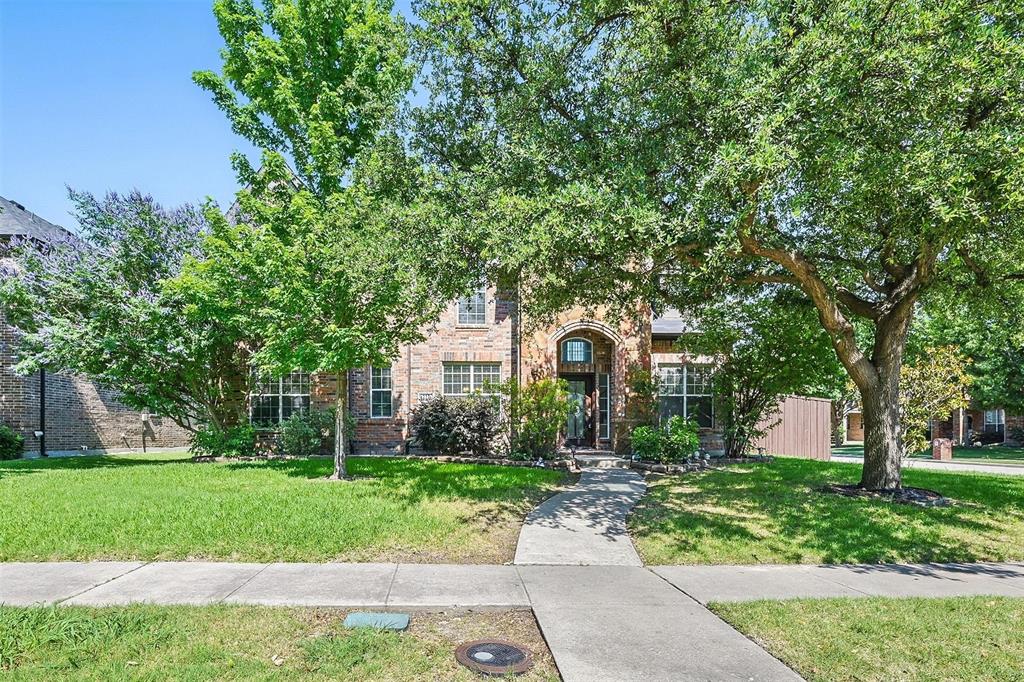 13236 Lime Ridge Drive Frisco, TX 75033 - Photo 1 of 1 a front view of a house with a garden