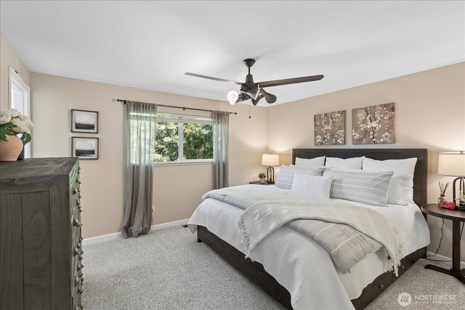 4629 128th Place Southeast Everett, WA 98208 - Photo 15 of 39 a bedroom with a large bed and a chandelier