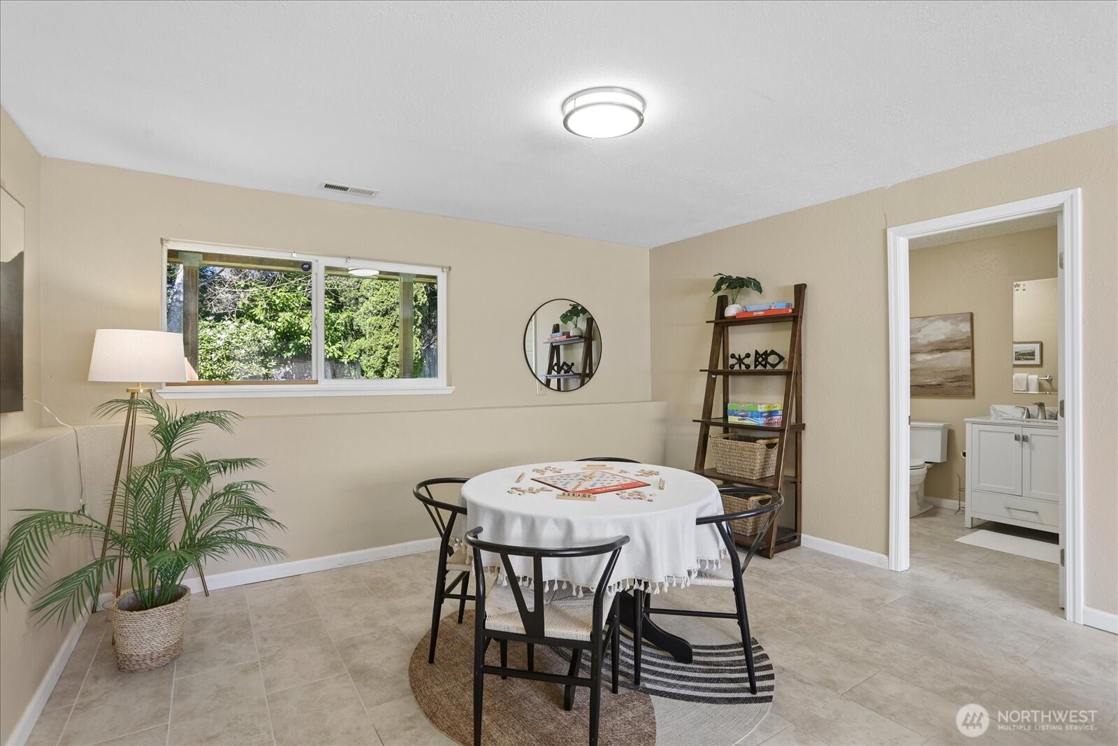 4629 128th Place Southeast Everett, WA 98208 - Photo 27 of 39 a view of a dining room with furniture and a potted plant