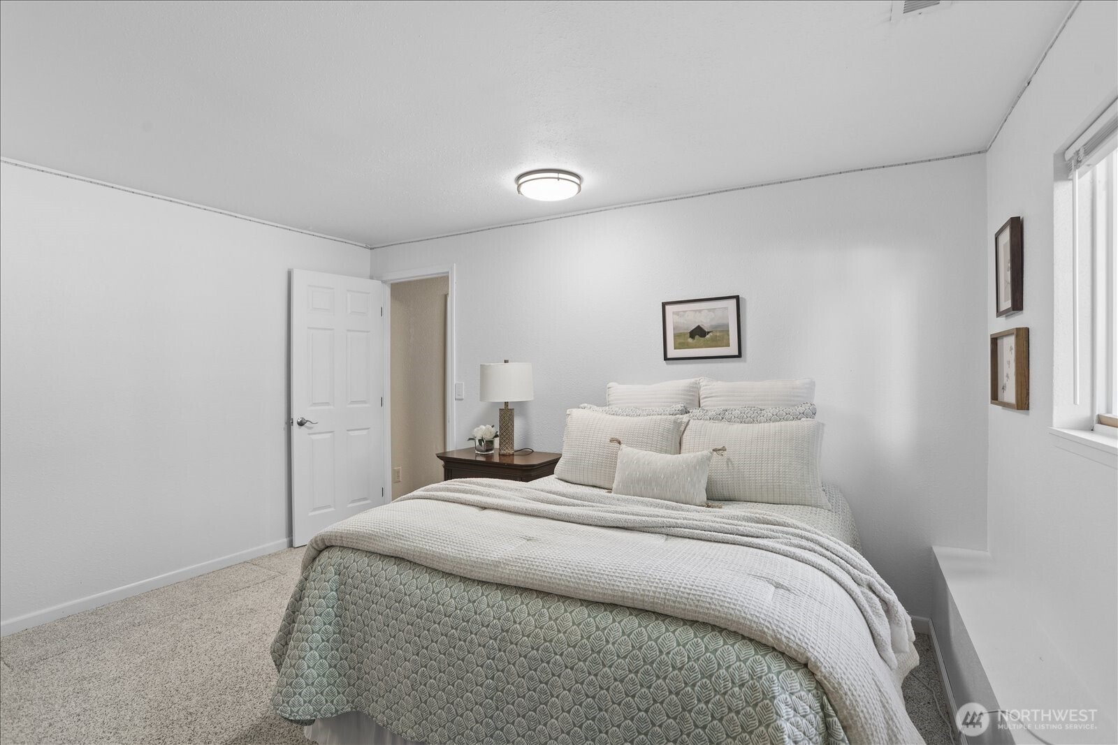 4629 128th Place Southeast Everett, WA 98208 - Photo 29 of 39 a bedroom with a bed and painting on the wall