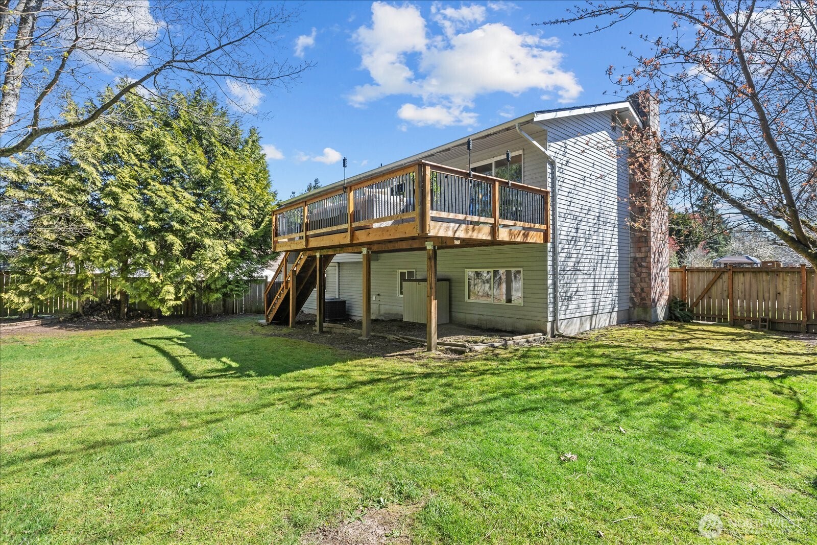 4629 128th Place Southeast Everett, WA 98208 - Photo 33 of 39 a view of a big house with a big yard and large trees