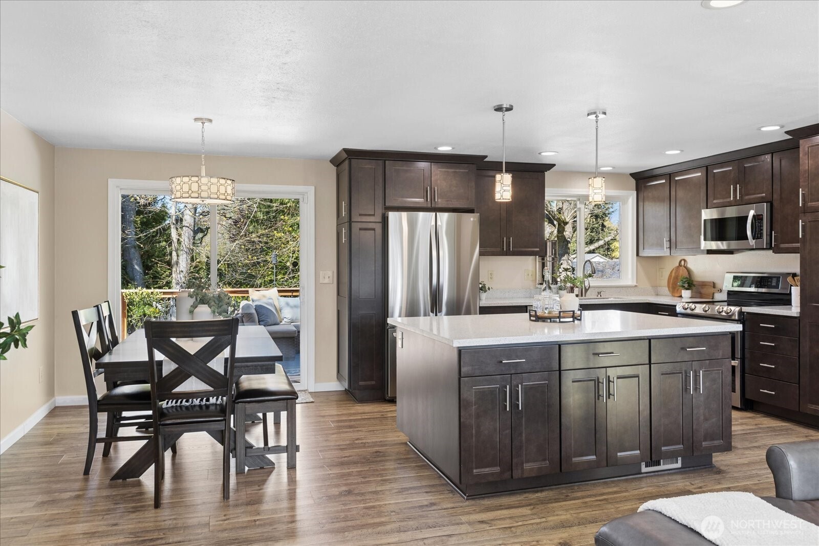 4629 128th Place Southeast Everett, WA 98208 - Photo 6 of 39 a kitchen with stainless steel appliances granite countertop a dining table chairs refrigerator and sink