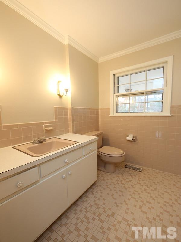 3412 Noel Court Raleigh, NC 27607 - Photo 11 of 25 a bathroom with a granite countertop sink a toilet and shower