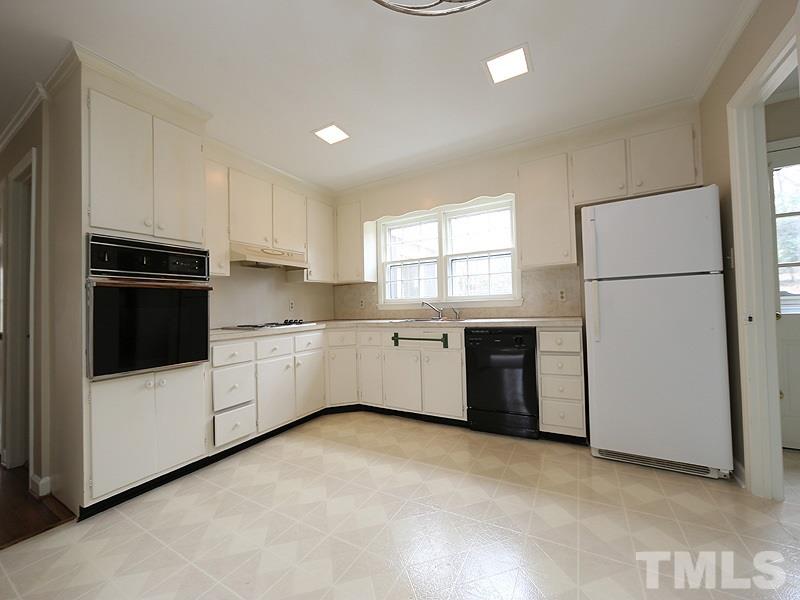 3412 Noel Court Raleigh, NC 27607 - Photo 13 of 25 a kitchen with stainless steel appliances a refrigerator sink and cabinets