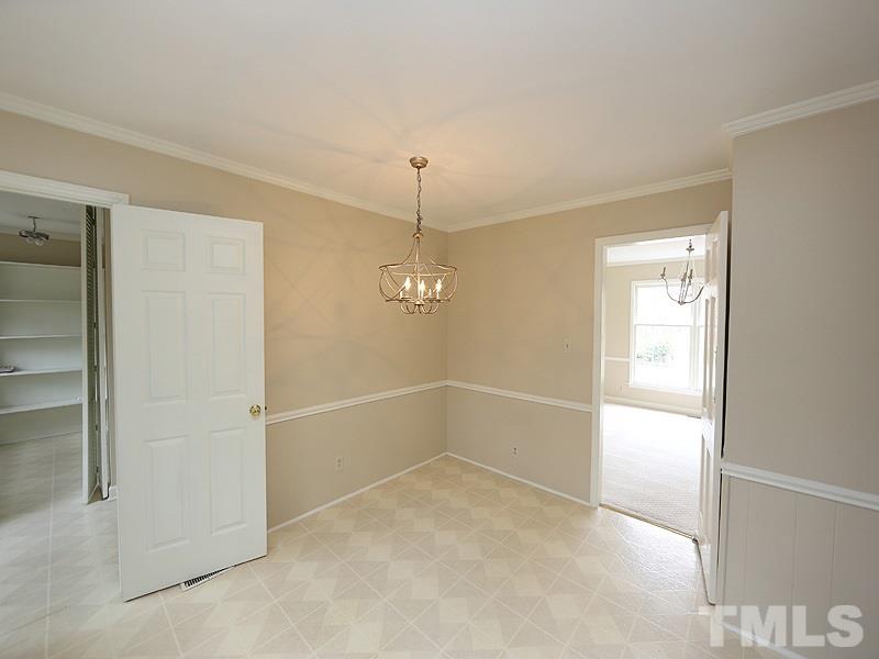3412 Noel Court Raleigh, NC 27607 - Photo 15 of 25 en empty room with windows and entrance