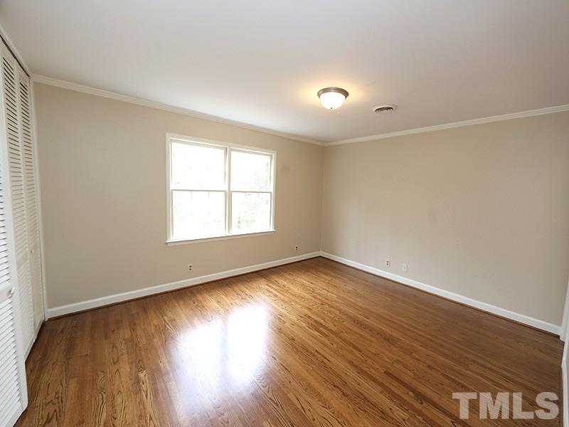 3412 Noel Court Raleigh, NC 27607 - Photo 17 of 25 an empty room with wooden floor and windows