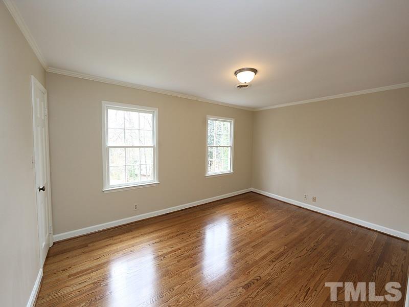 3412 Noel Court Raleigh, NC 27607 - Photo 19 of 25 an empty room with wooden floor and windows