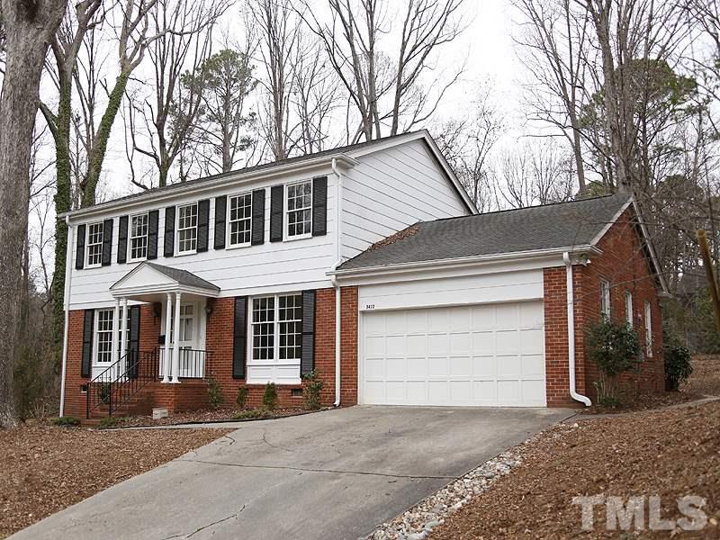 3412 Noel Court Raleigh, NC 27607 - Photo 3 of 25 a front view of a house with a yard and garage