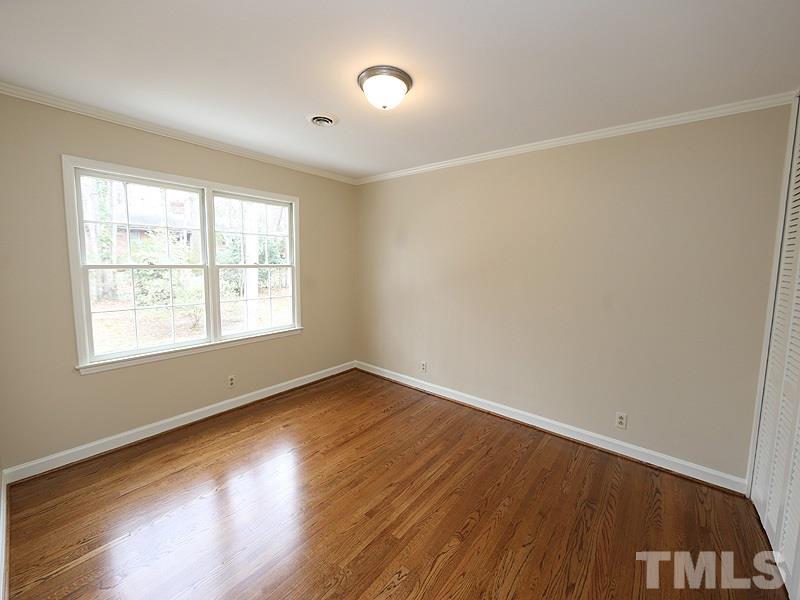 3412 Noel Court Raleigh, NC 27607 - Photo 21 of 25 an empty room with wooden floor and windows
