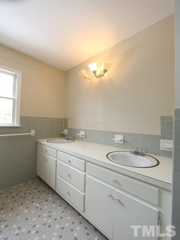 3412 Noel Court Raleigh, NC 27607 - Photo 23 of 25 a bathroom with a granite countertop sink and a mirror