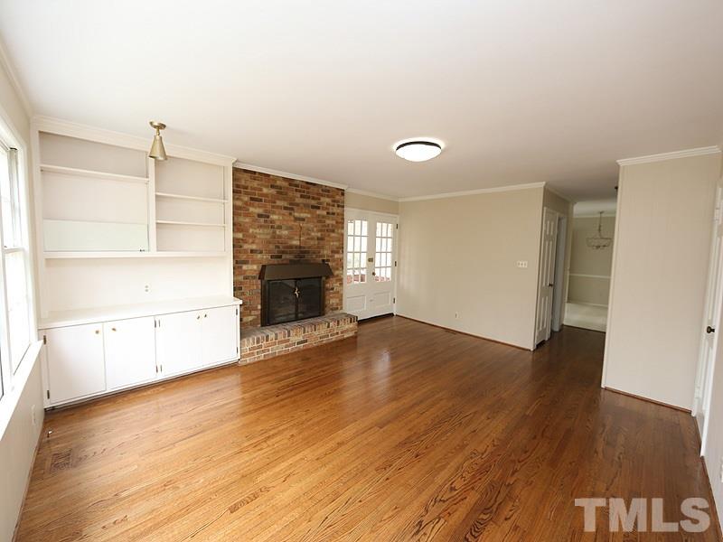 3412 Noel Court Raleigh, NC 27607 - Photo 9 of 25 a view of empty room with wooden floor and fireplace