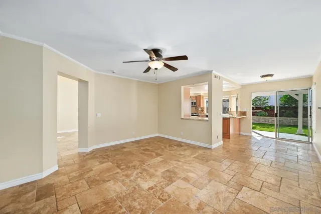 a view of a livingroom with a ceiling fan and window