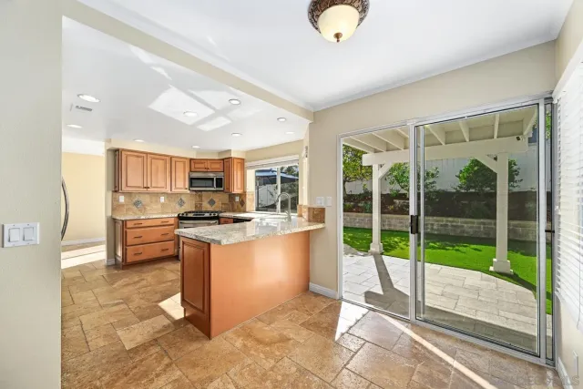 a kitchen with stainless steel appliances granite countertop a stove and a sink