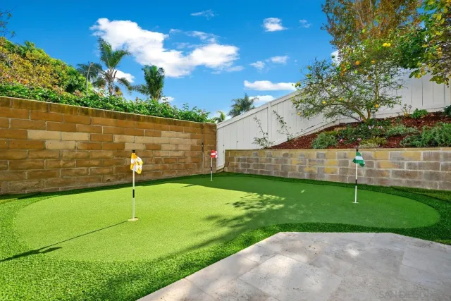 a view of a backyard with plants and a lake view