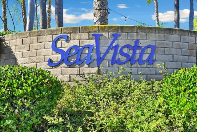 a street sign that is on a brick wall