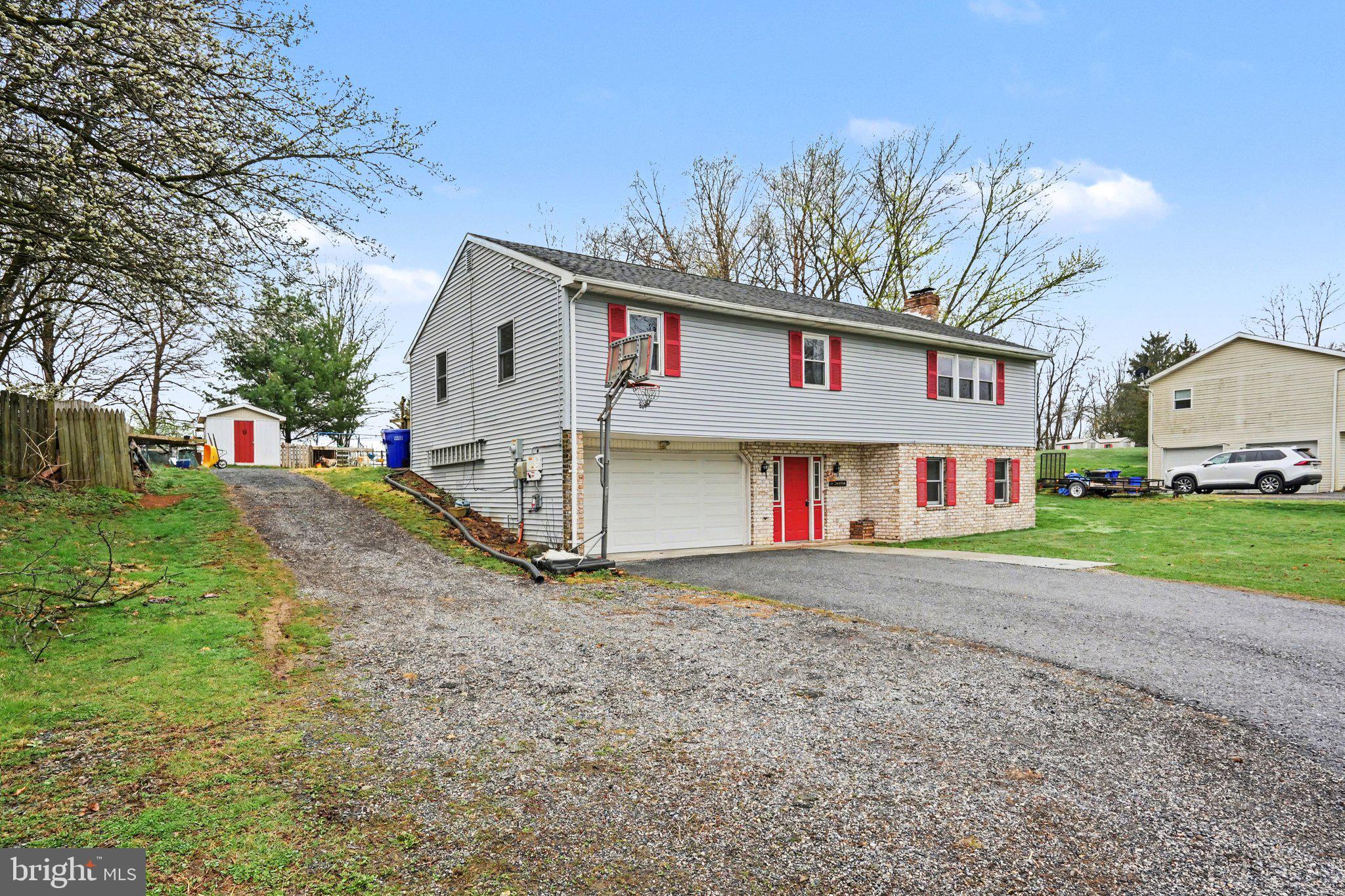 711 West Siddonsburg Road Dillsburg, PA 17019 - Photo 25 of 26 a view of a white house with a big yard and large trees