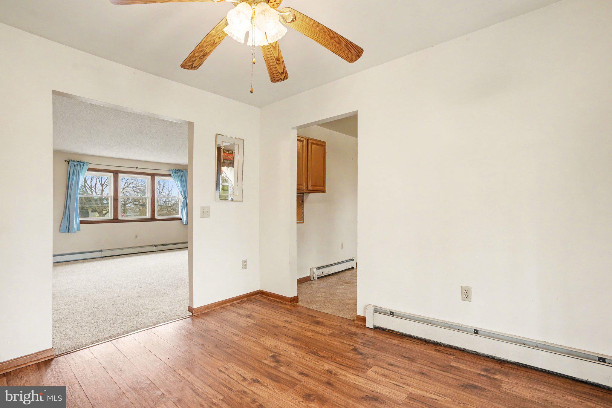 711 West Siddonsburg Road Dillsburg, PA 17019 - Photo 6 of 26 an empty room with wooden floor chandelier and windows