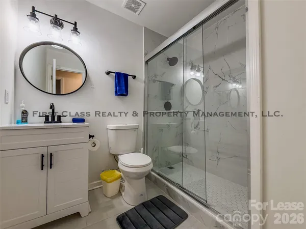 a bathroom with a toilet a sink and a mirror