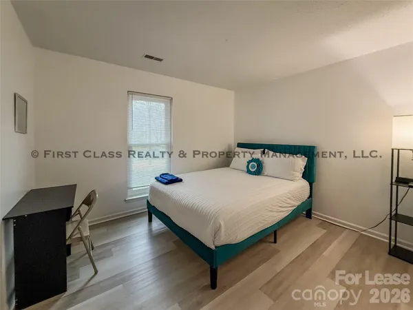 a bedroom with a bed and a desk