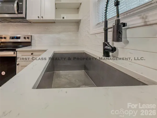 a kitchen with a sink and cabinets