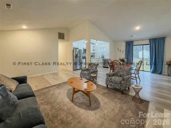 a living room with furniture and white walls