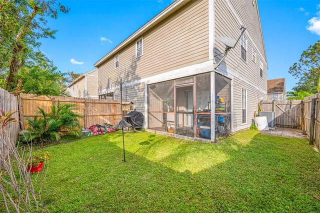 a view of a house with a yard and sitting area