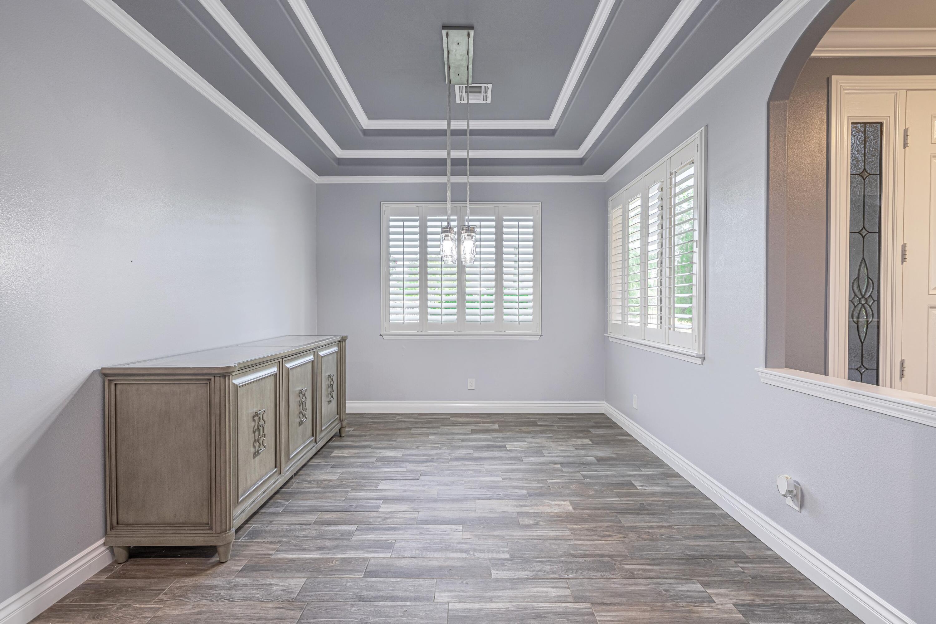 4023 Derby Circle Lancaster, CA 93536 - Photo 9 of 53 a view of an empty room with wooden floor and a window