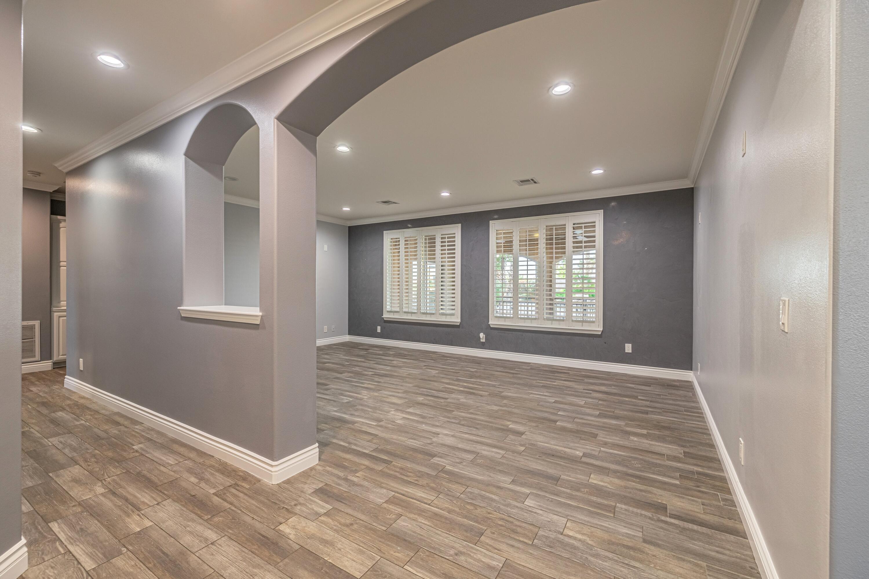 4023 Derby Circle Lancaster, CA 93536 - Photo 10 of 53 a view of an empty room with wooden floor and a window