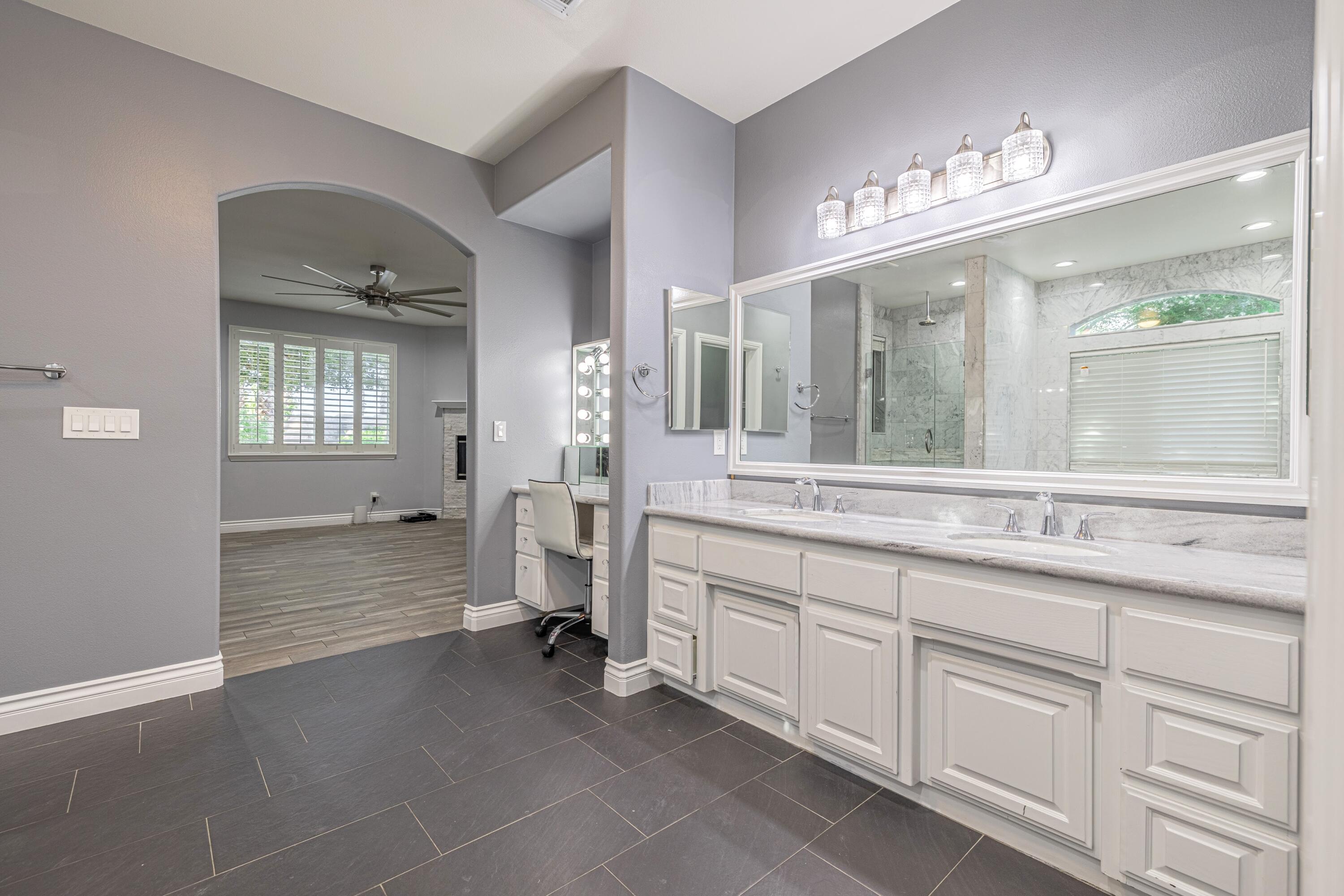 4023 Derby Circle Lancaster, CA 93536 - Photo 19 of 53 a spacious bathroom with a granite countertop sink a large mirror and a bathtub