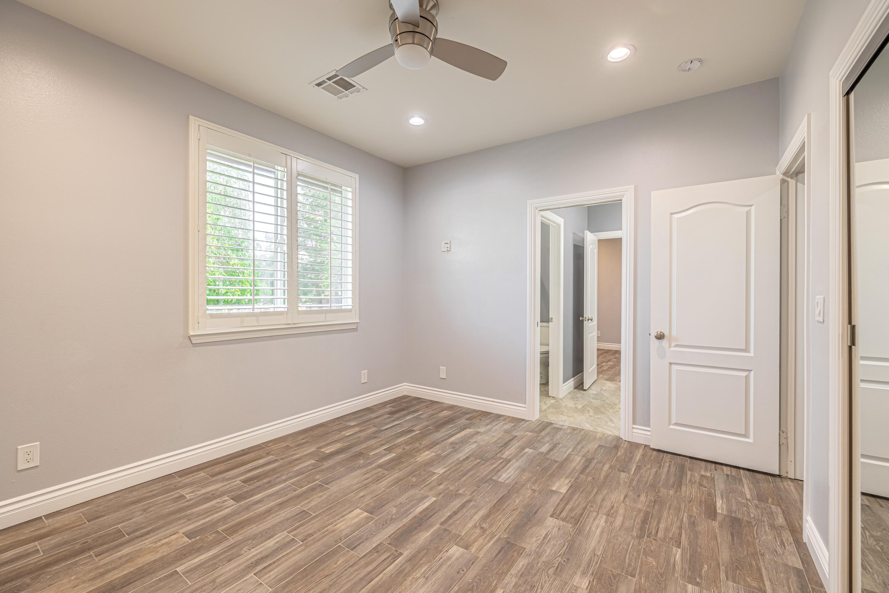 4023 Derby Circle Lancaster, CA 93536 - Photo 22 of 53 an empty room with wooden floor cabinet and windows