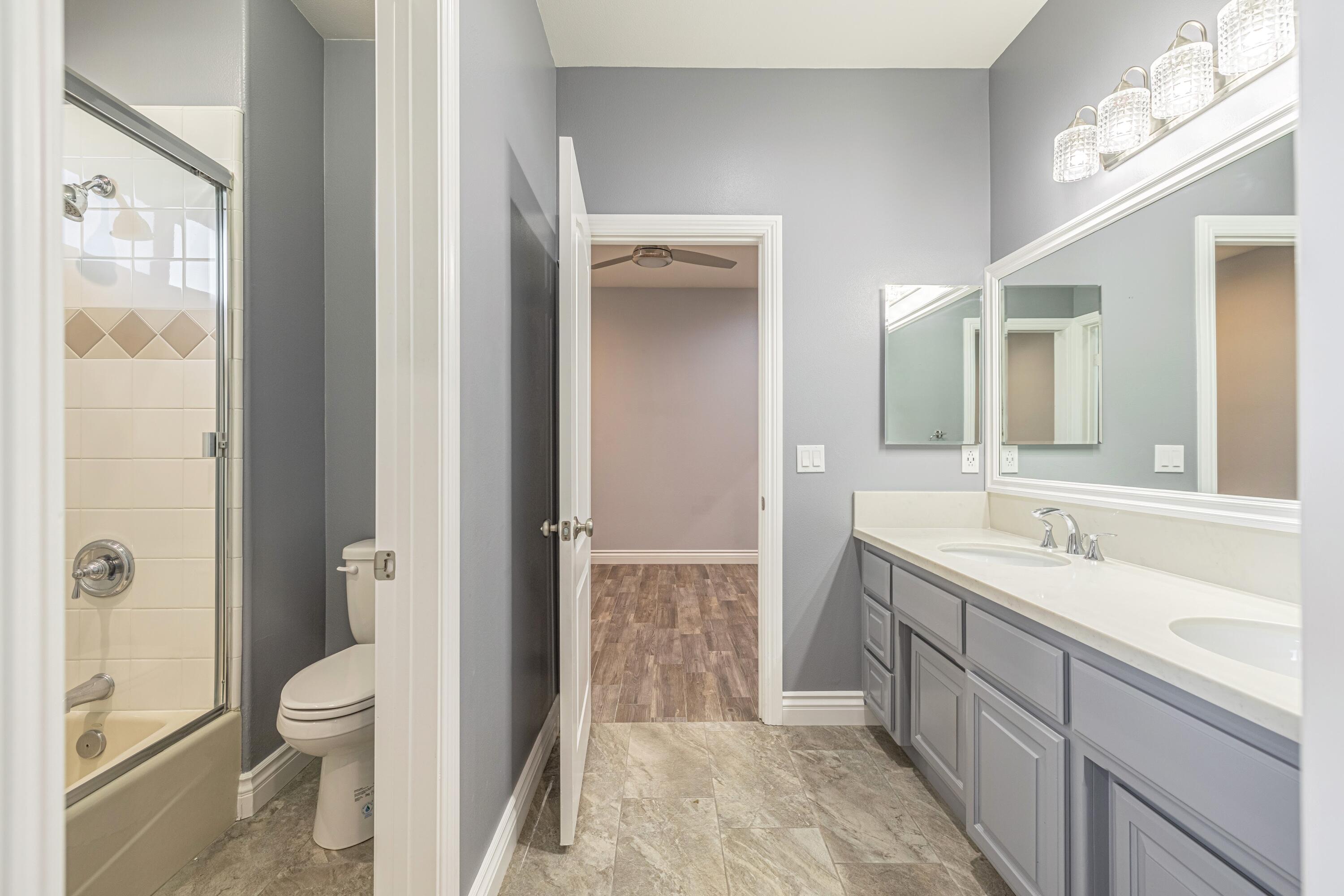 4023 Derby Circle Lancaster, CA 93536 - Photo 23 of 53 a spacious bathroom with a granite countertop sink a toilet and shower