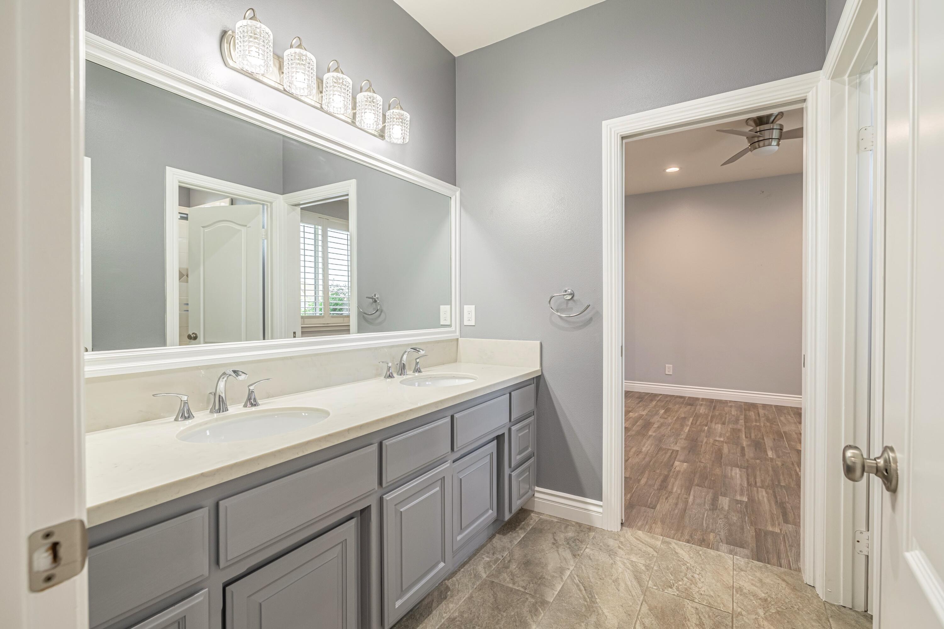4023 Derby Circle Lancaster, CA 93536 - Photo 24 of 53 a bathroom with a double vanity sink mirror and