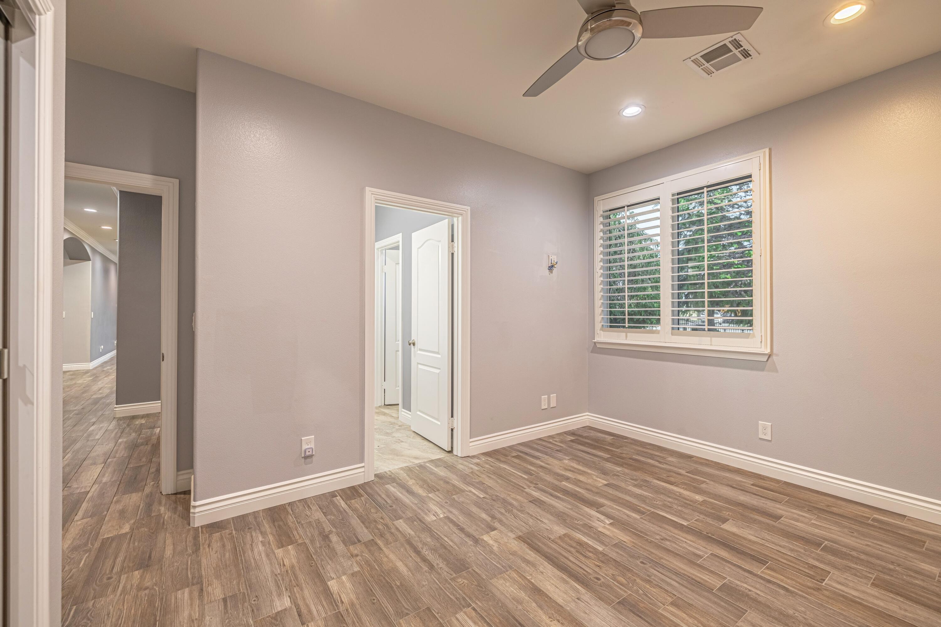 4023 Derby Circle Lancaster, CA 93536 - Photo 25 of 53 a view of an empty room with wooden floor and a window