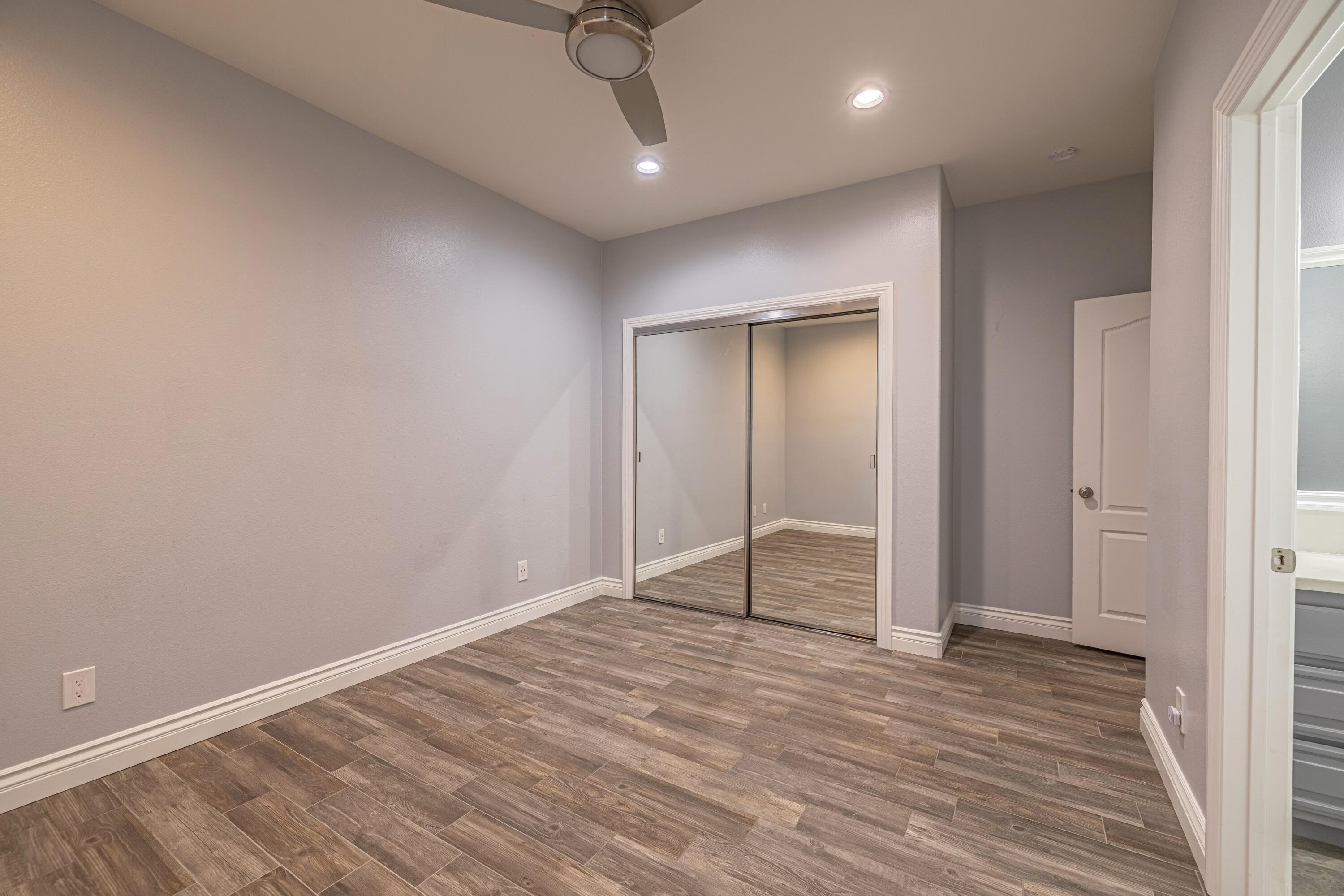 4023 Derby Circle Lancaster, CA 93536 - Photo 26 of 53 an empty room with wooden floor and closet
