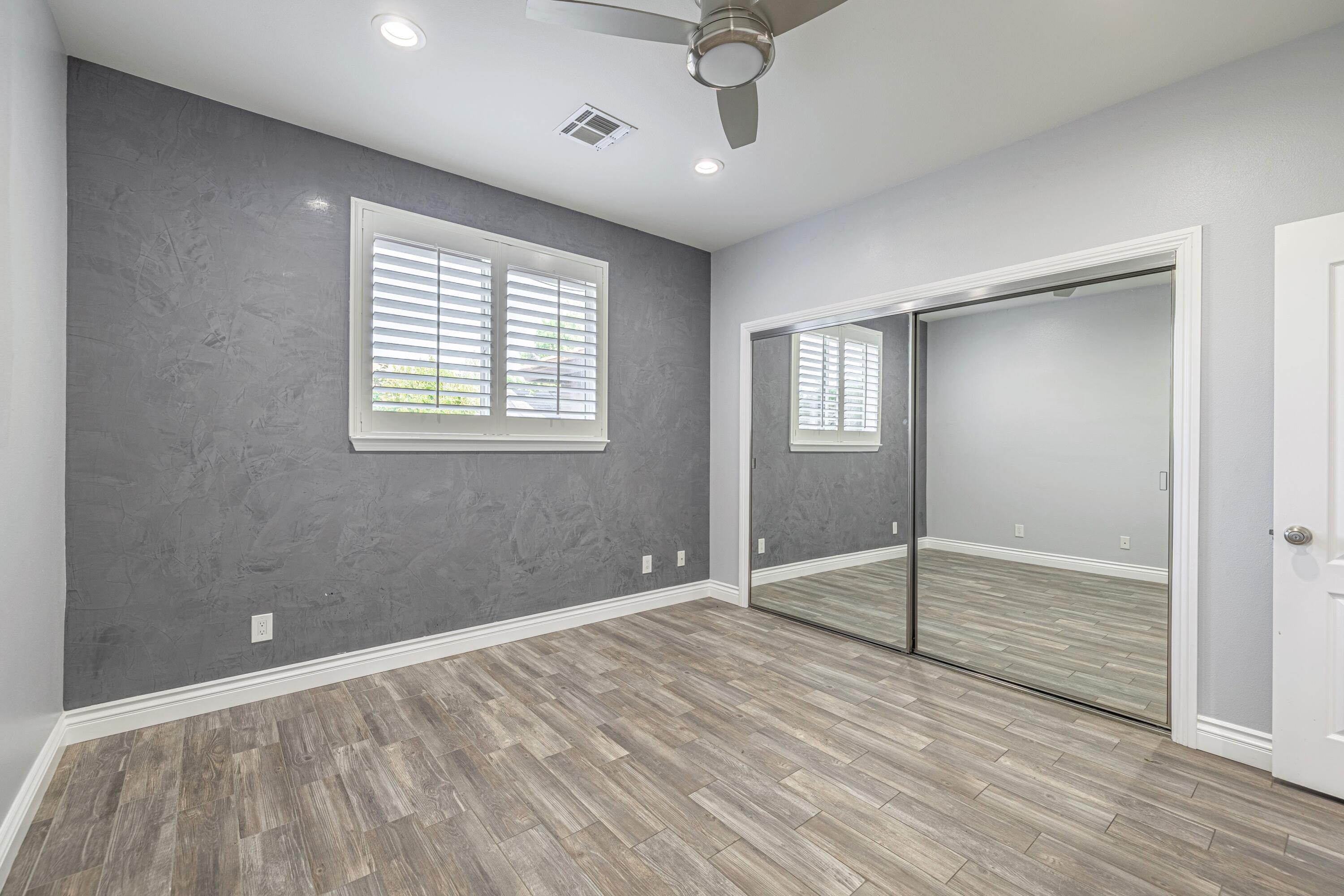 4023 Derby Circle Lancaster, CA 93536 - Photo 28 of 53 a view of an empty room with a window and wooden floor