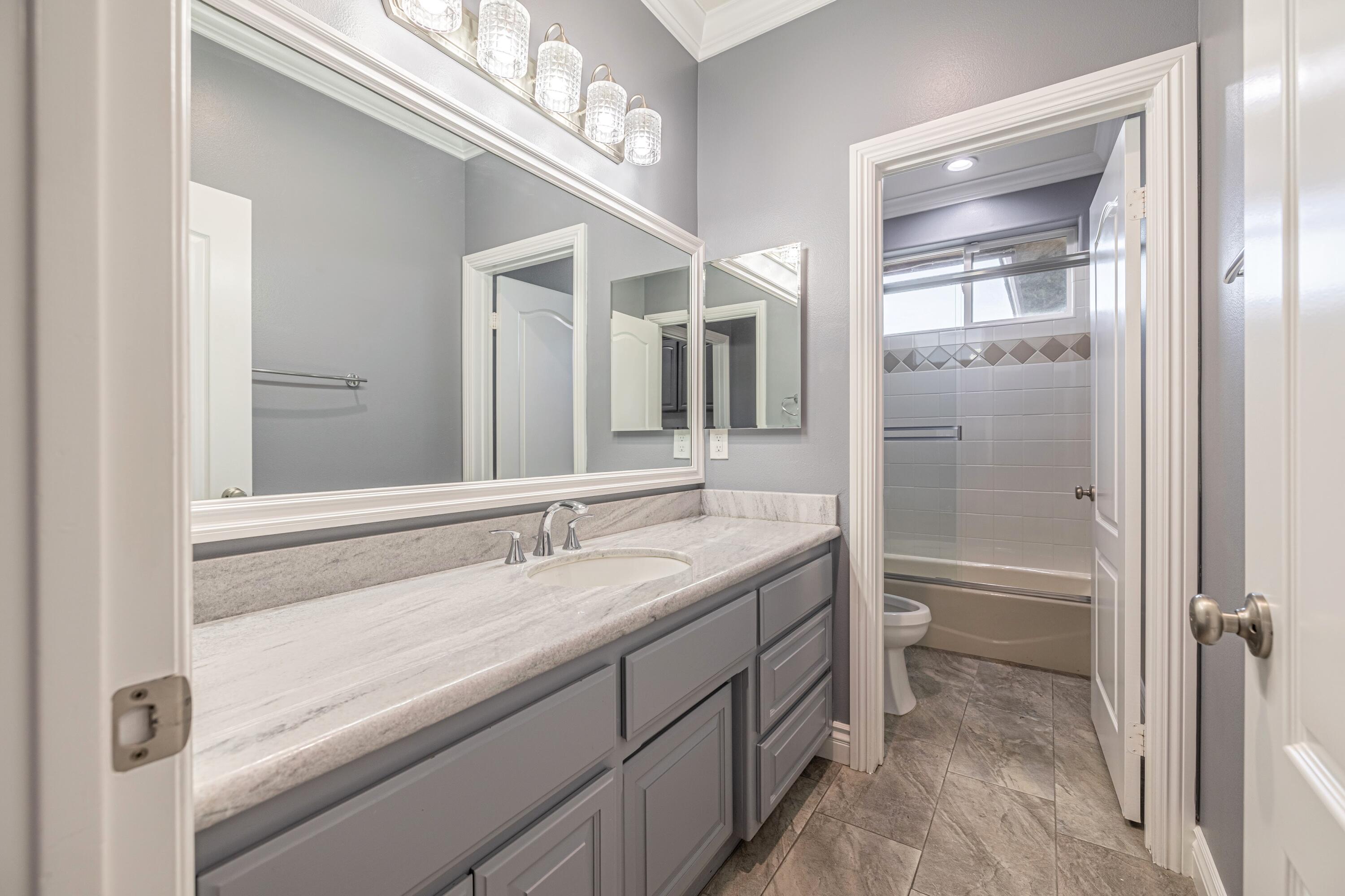 4023 Derby Circle Lancaster, CA 93536 - Photo 29 of 53 a bathroom with a granite countertop sink mirror and