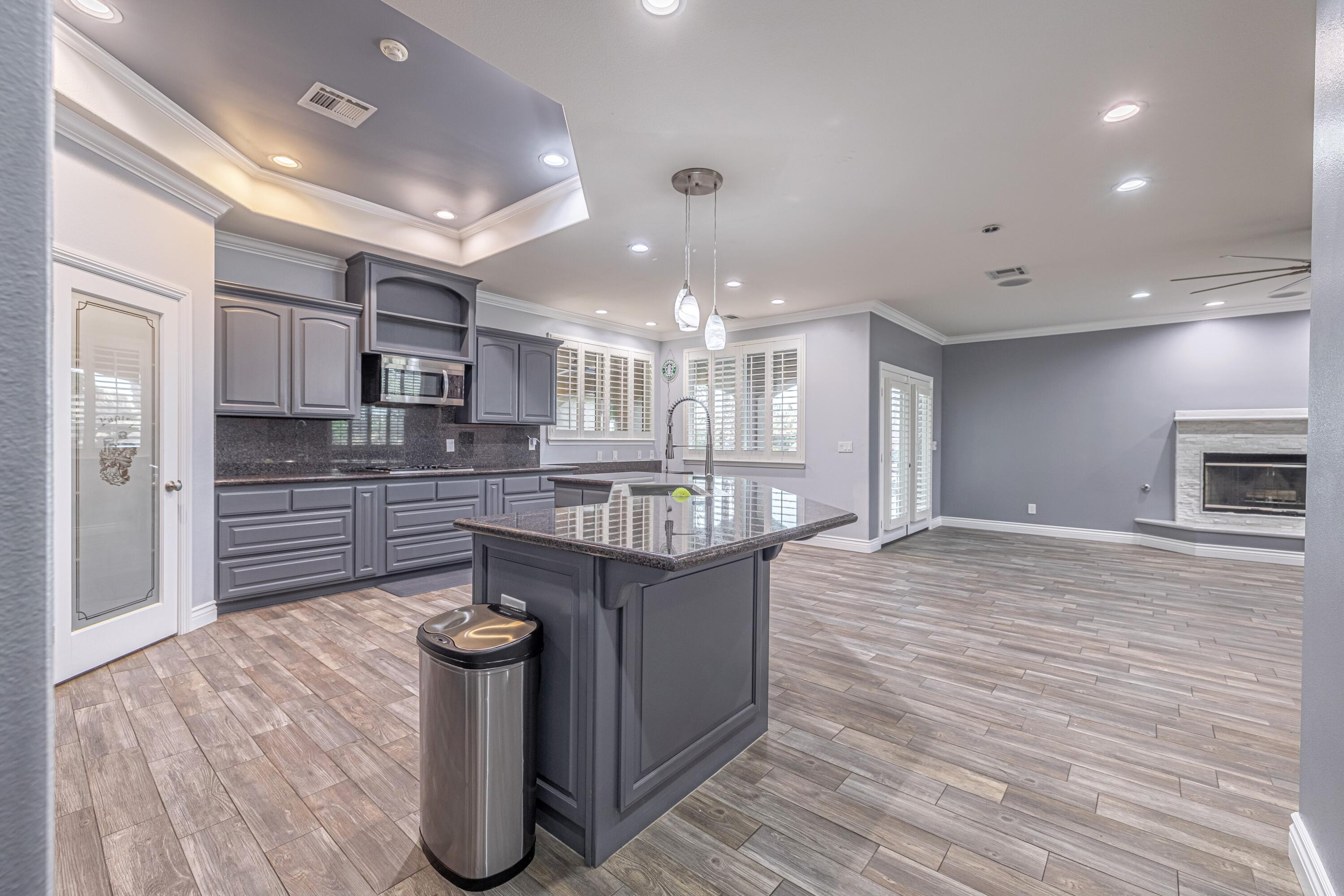 4023 Derby Circle Lancaster, CA 93536 - Photo 52 of 53 a kitchen with stainless steel appliances granite countertop a sink stove and refrigerator