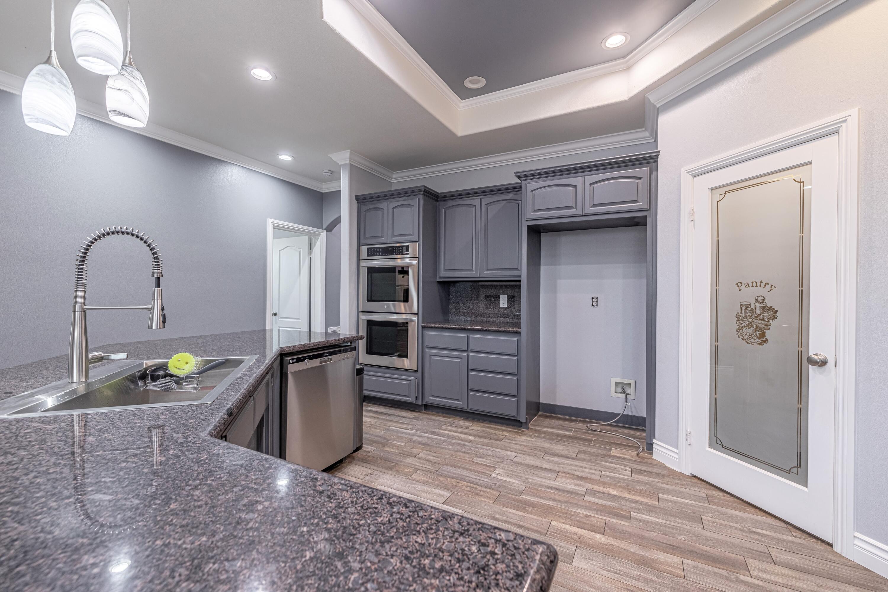 4023 Derby Circle Lancaster, CA 93536 - Photo 4 of 53 a kitchen with stainless steel appliances granite countertop a refrigerator and a stove top oven