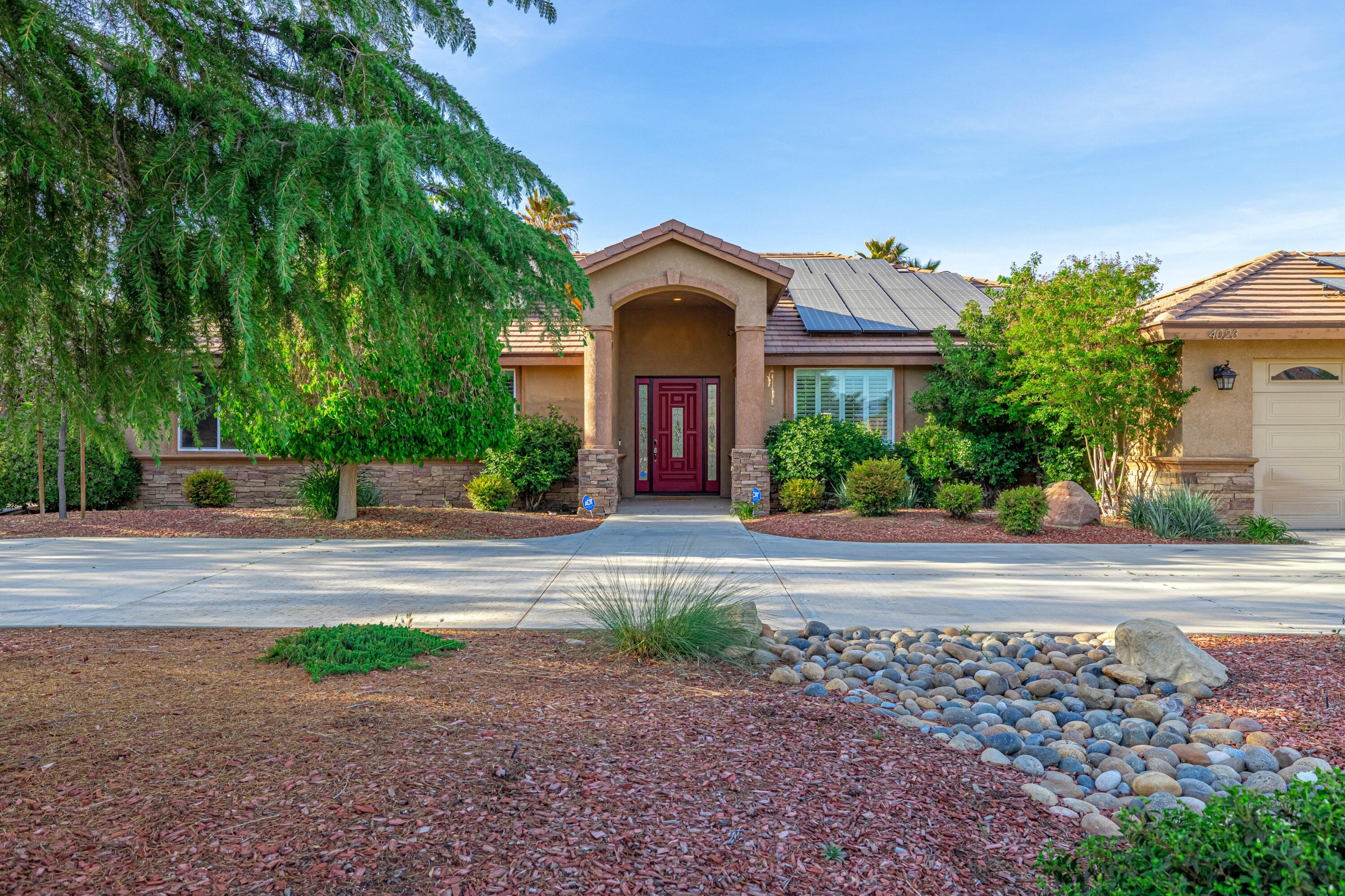 4023 Derby Circle Lancaster, CA 93536 - Photo 50 of 53 a front view of a house with a yard and garage