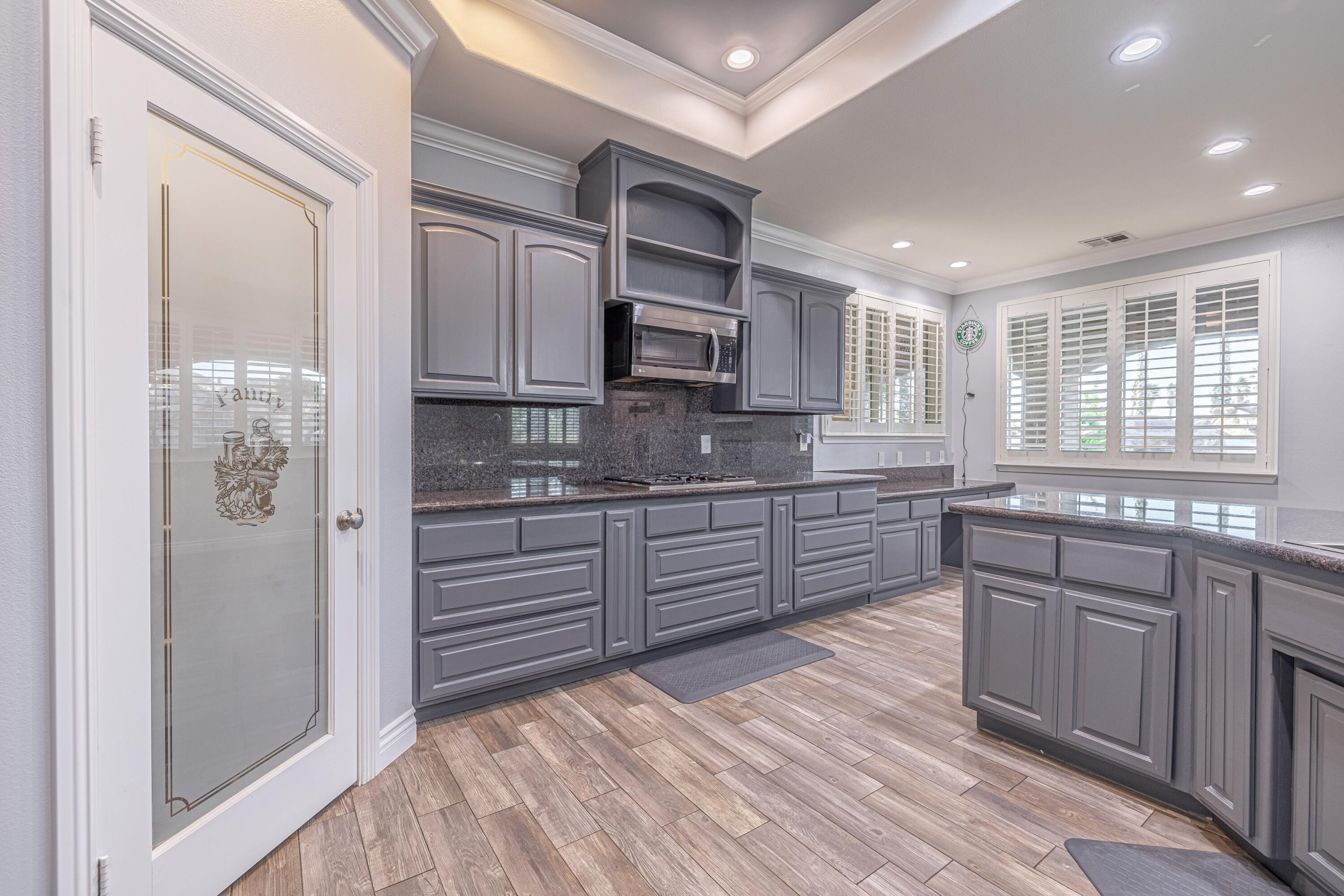 4023 Derby Circle Lancaster, CA 93536 - Photo 5 of 53 a kitchen with stainless steel appliances granite countertop a stove a sink and a refrigerator