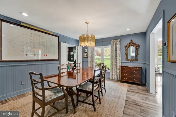 a room with a bookshelf and a large window