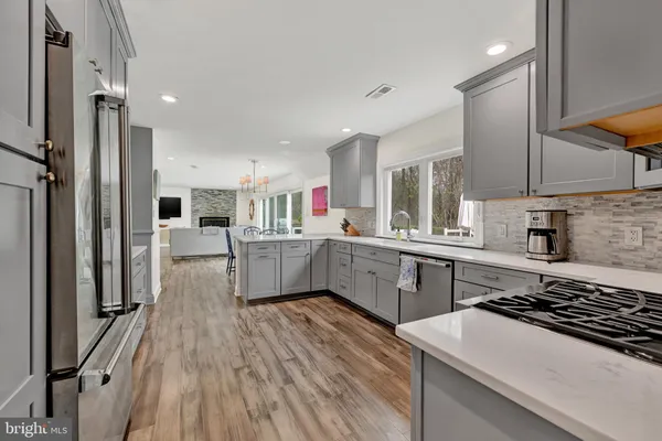 a kitchen with a sink stove and cabinets