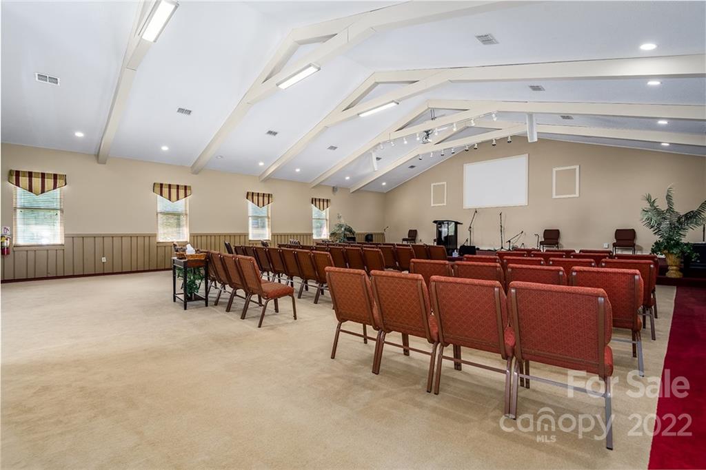 3521 Section House Road Hickory, NC 28601 - Photo 17 of 48 a room with lots of chairs a desk a large window and a rug