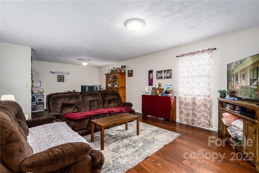 3521 Section House Road Hickory, NC 28601 - Photo 38 of 48 a living room with furniture a rug and a wooden floor