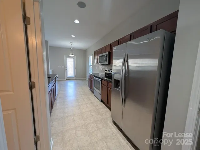 a view of a refrigerator in kitchen and wooden floor